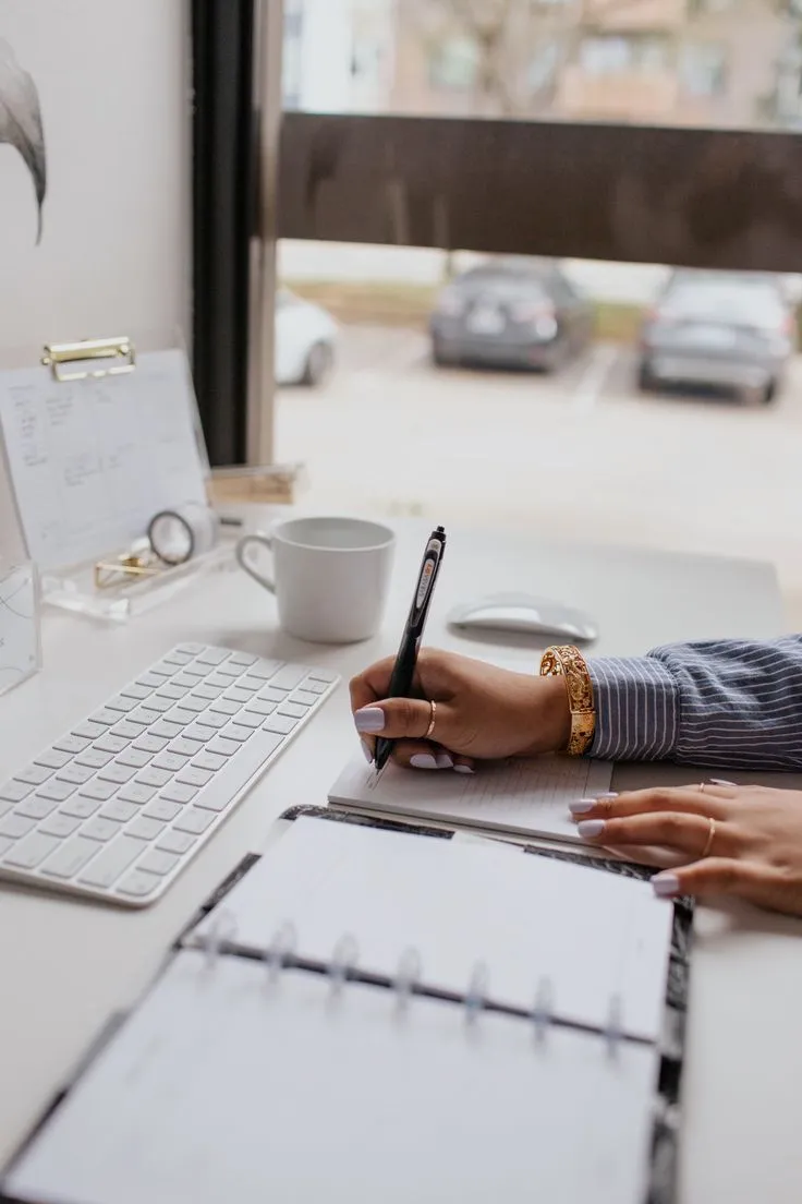 Minimal desk with planner and ceramic objects